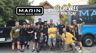 A group of people stand in front of some vans